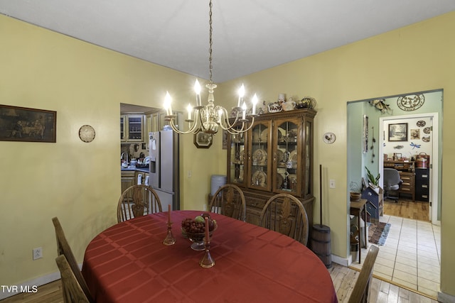 dining space featuring a chandelier and light hardwood / wood-style flooring