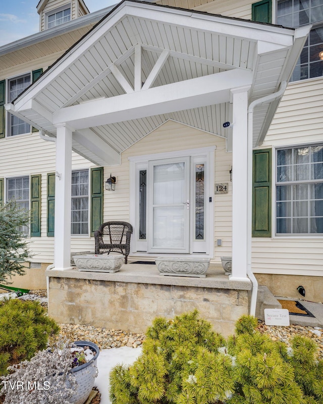 doorway to property featuring covered porch