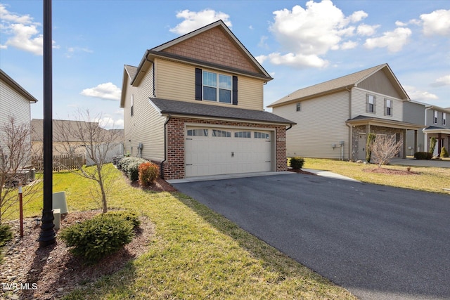 view of front facade with driveway, brick siding, a front lawn, and an attached garage