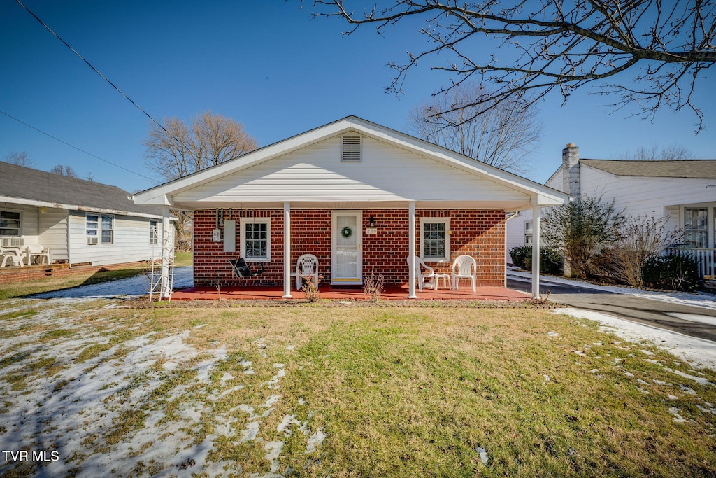 view of front of home with a porch and a front lawn