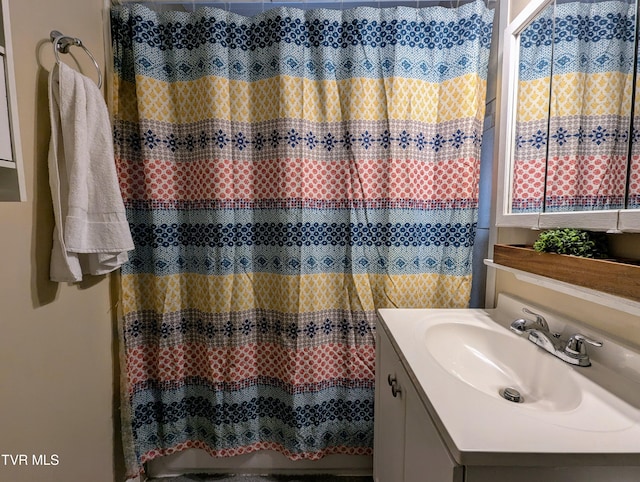 bathroom featuring vanity and walk in shower