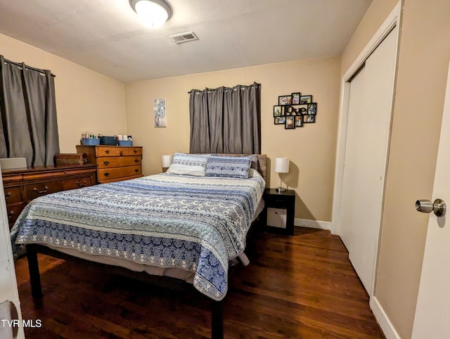 bedroom featuring dark hardwood / wood-style flooring and a closet