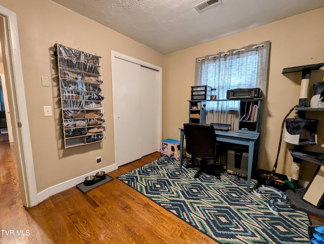 office area featuring a textured ceiling and hardwood / wood-style flooring