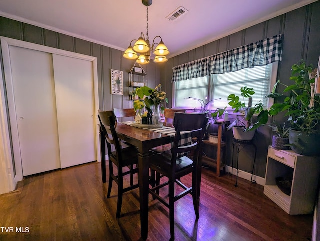 dining room with a chandelier and dark hardwood / wood-style flooring