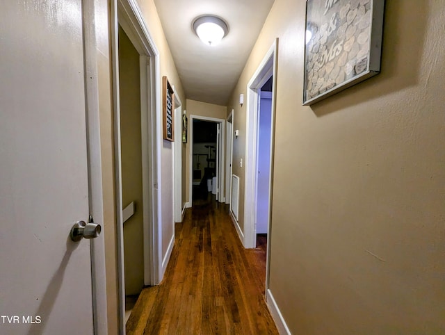 corridor with dark wood-type flooring