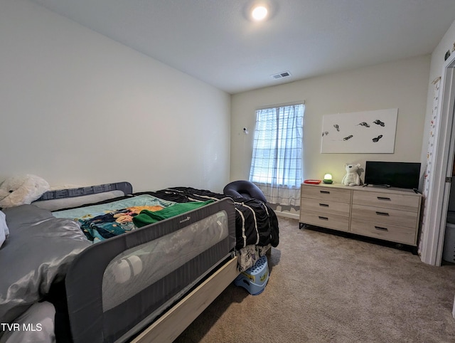 bedroom with light colored carpet