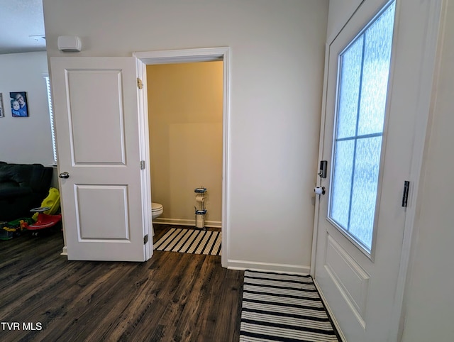 doorway with dark wood-type flooring