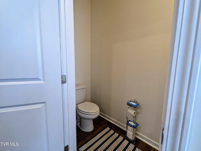 bathroom with hardwood / wood-style floors and toilet