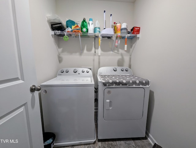 washroom with dark hardwood / wood-style floors and independent washer and dryer