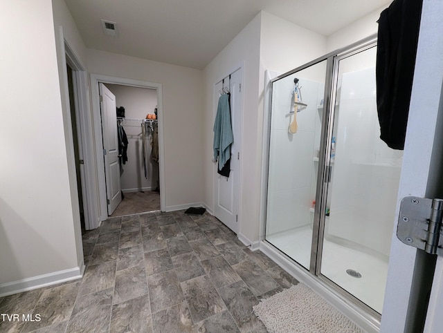 bathroom featuring a shower with shower door