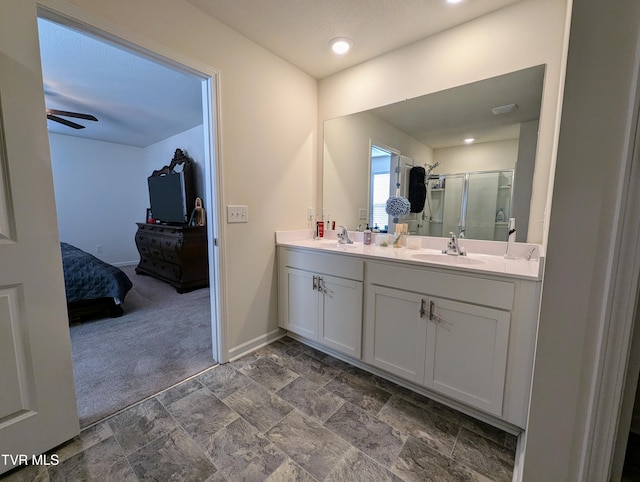 bathroom featuring an enclosed shower, vanity, and ceiling fan