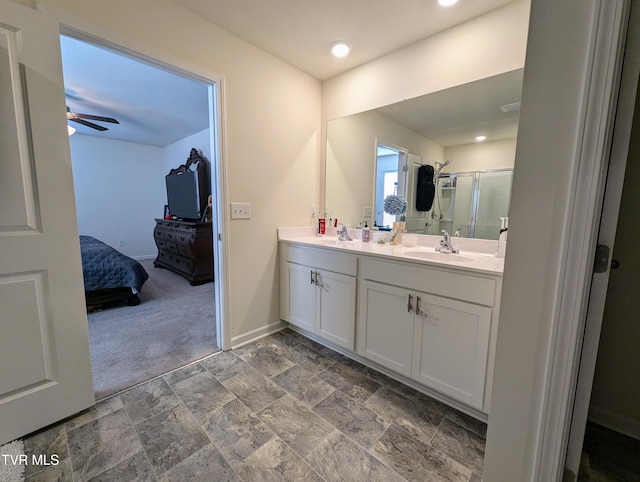 bathroom featuring an enclosed shower, ceiling fan, and vanity