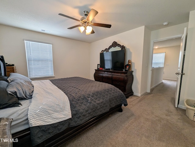 bedroom featuring ceiling fan and light carpet