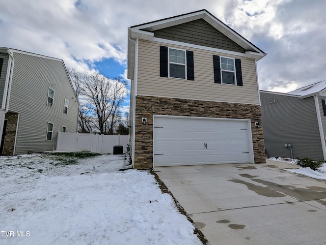 view of front of house with central AC unit and a garage