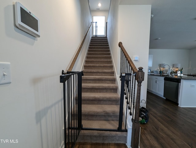 stairway with hardwood / wood-style flooring