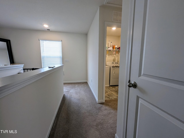 hall with washer and dryer and carpet flooring