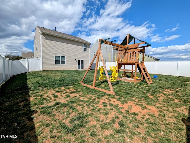 rear view of property with a fenced backyard, a yard, and a playground