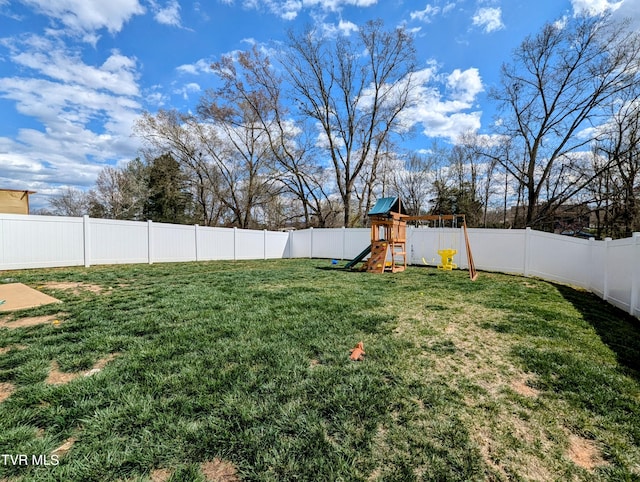 view of yard with a fenced backyard and a playground
