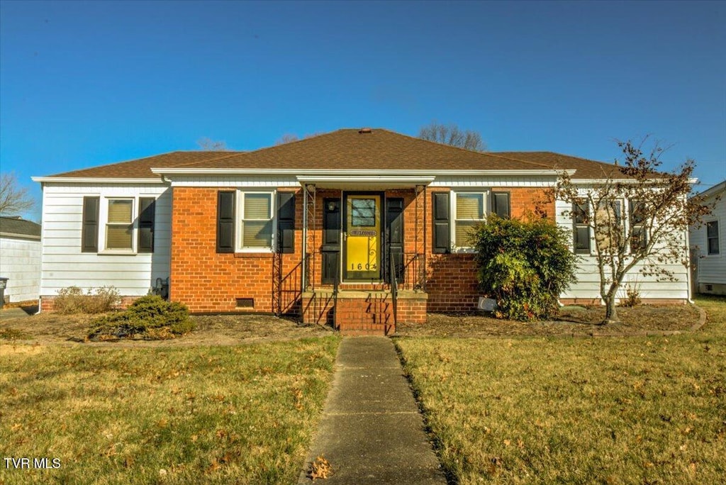 bungalow-style home with a front lawn