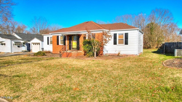 view of front of property with a front yard and a garage