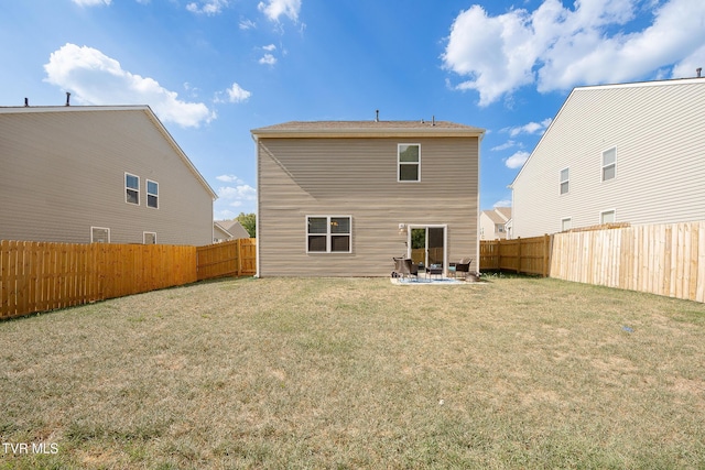 back of house featuring a yard