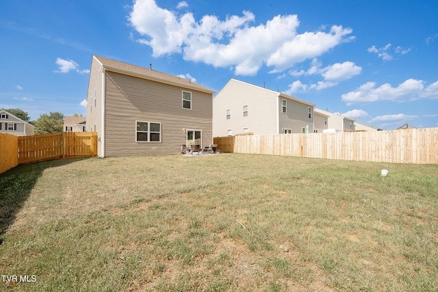 rear view of property with a lawn