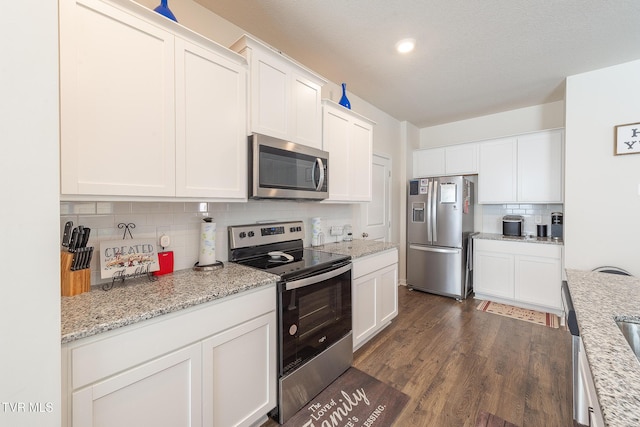 kitchen featuring white cabinets, decorative backsplash, dark hardwood / wood-style floors, and stainless steel appliances