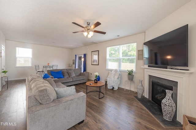 living room featuring dark hardwood / wood-style floors and ceiling fan