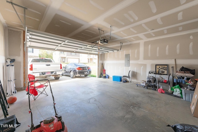 garage with electric panel and a garage door opener