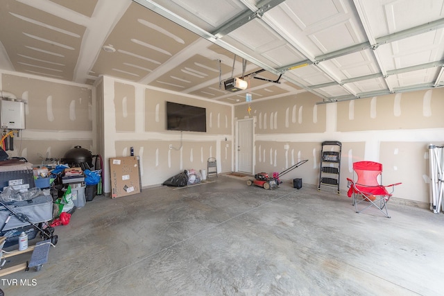 garage featuring a garage door opener and water heater