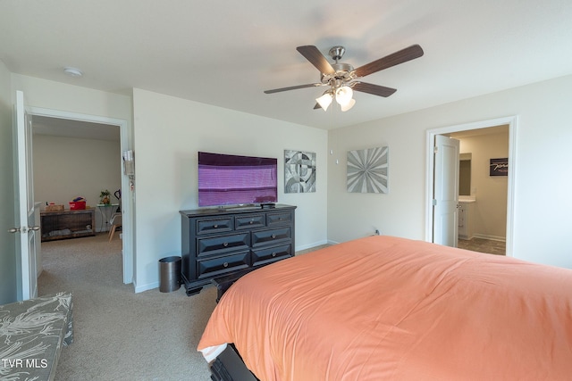 carpeted bedroom with ceiling fan and ensuite bathroom