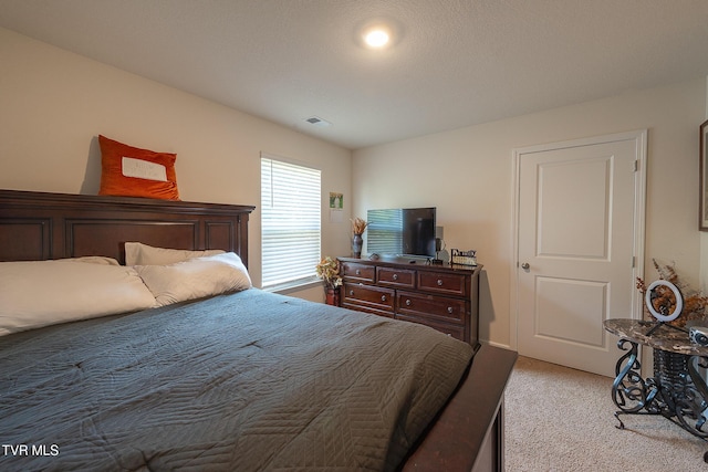 bedroom with light carpet