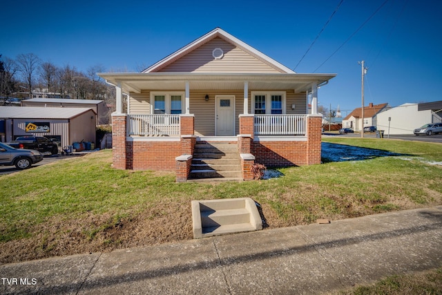 bungalow featuring a front yard and a porch