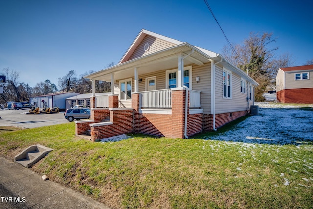 bungalow featuring a front lawn and a porch