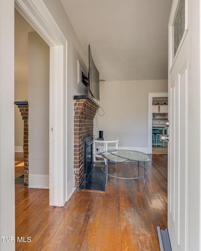 living room featuring a fireplace and hardwood / wood-style flooring