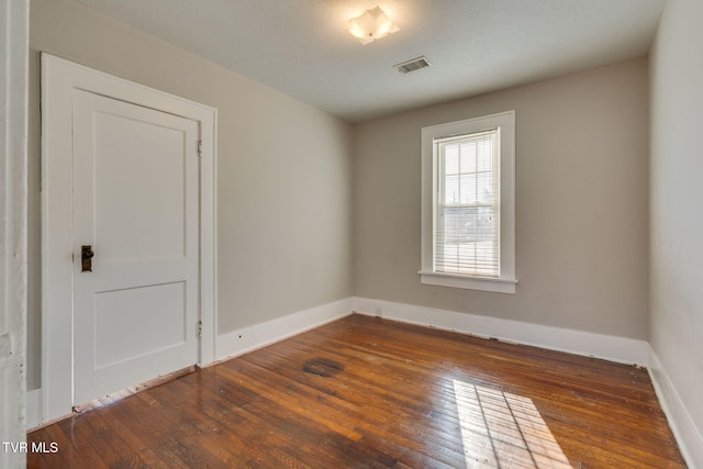 spare room featuring dark hardwood / wood-style floors