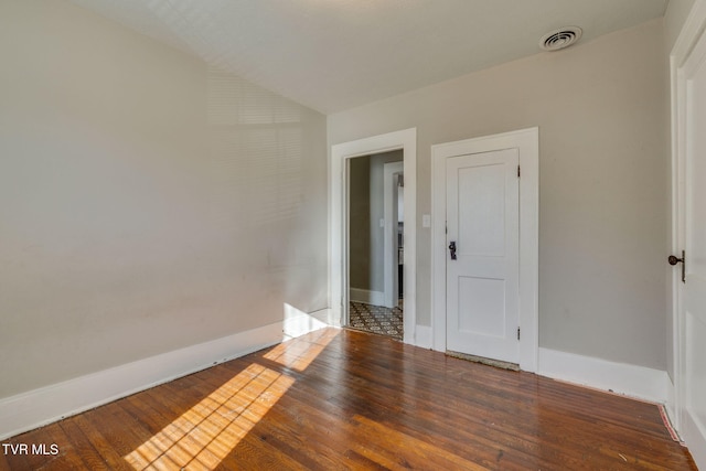 spare room with hardwood / wood-style flooring