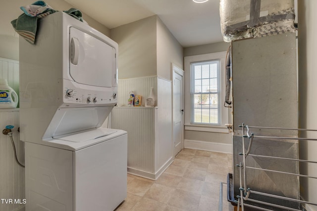 laundry room featuring stacked washer / drying machine