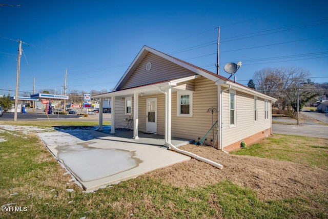 rear view of house featuring a yard