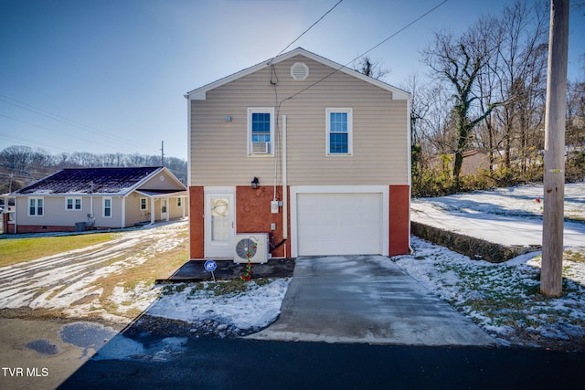 view of property featuring a garage and ac unit