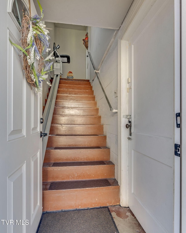 staircase with concrete floors