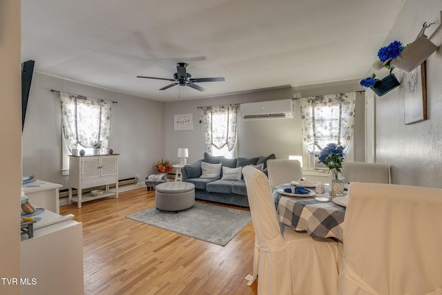 living room featuring ceiling fan, plenty of natural light, baseboard heating, and hardwood / wood-style flooring