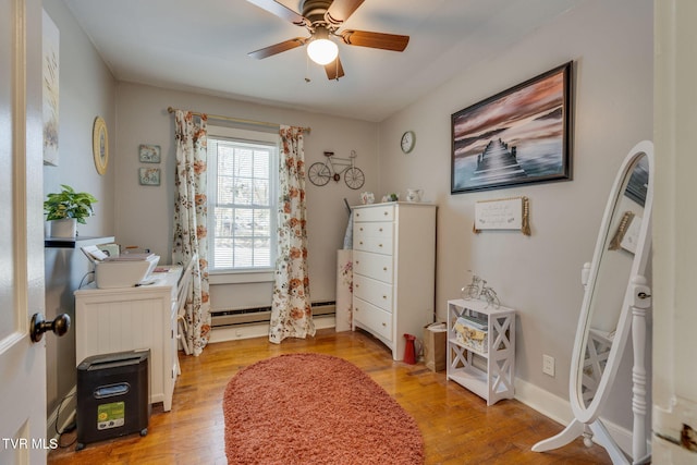 interior space featuring ceiling fan, baseboard heating, and light hardwood / wood-style flooring