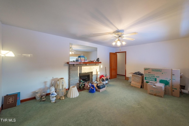 rec room featuring carpet flooring, a fireplace, and ceiling fan