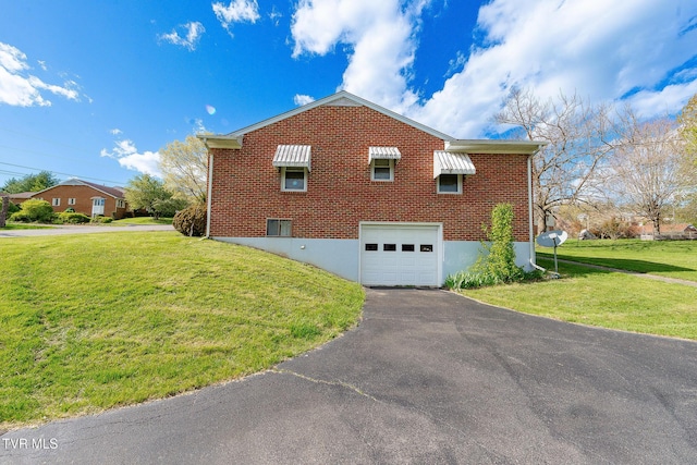 view of home's exterior featuring a garage, aphalt driveway, brick siding, and a lawn