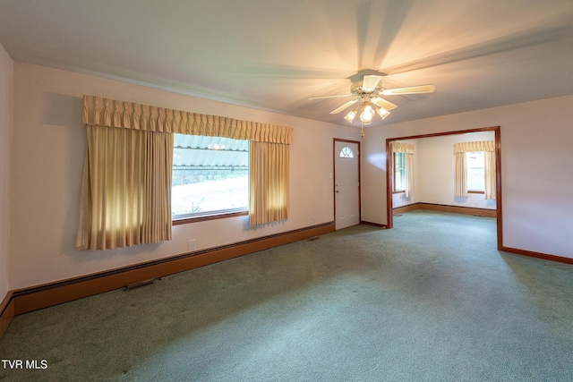 carpeted empty room with baseboards, a ceiling fan, and a baseboard heating unit