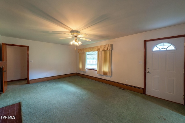 entrance foyer with ceiling fan, carpet flooring, and baseboards