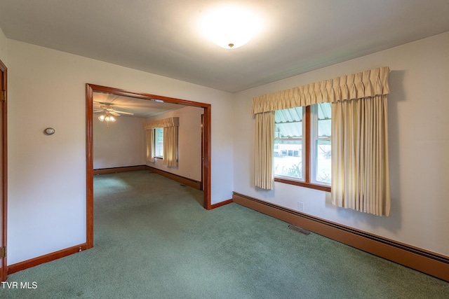 unfurnished room with a wealth of natural light, baseboard heating, baseboards, and carpet floors