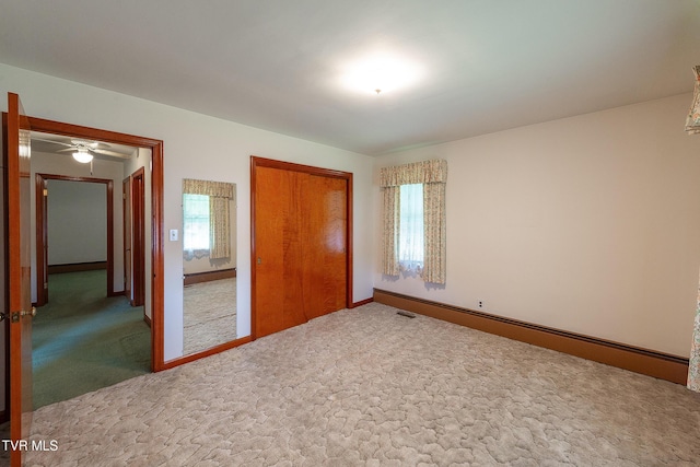 unfurnished bedroom featuring a closet, baseboards, and carpet floors