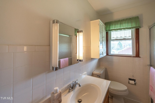 full bathroom with vanity, an enclosed shower, tile walls, and toilet